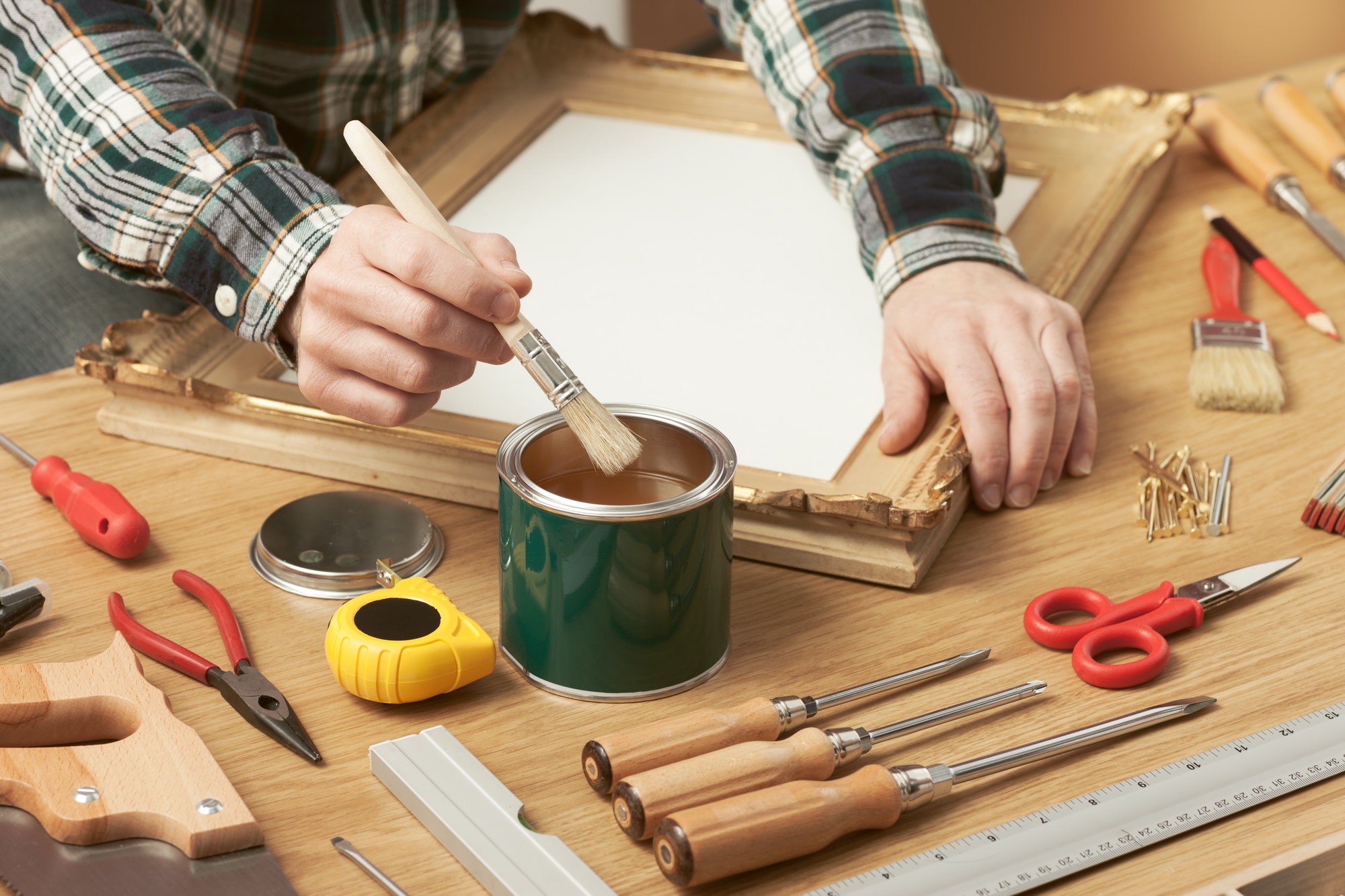 Decorator varnishing a wooden frame